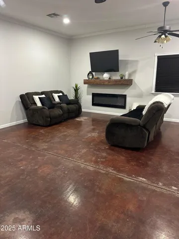 a living room with furniture a lamp and a flat screen tv