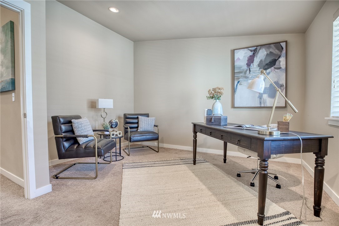 946 North 96th Street Seattle, WA 98103 - Photo 18 of 24 a living room with furniture a rug and a painting on the wall