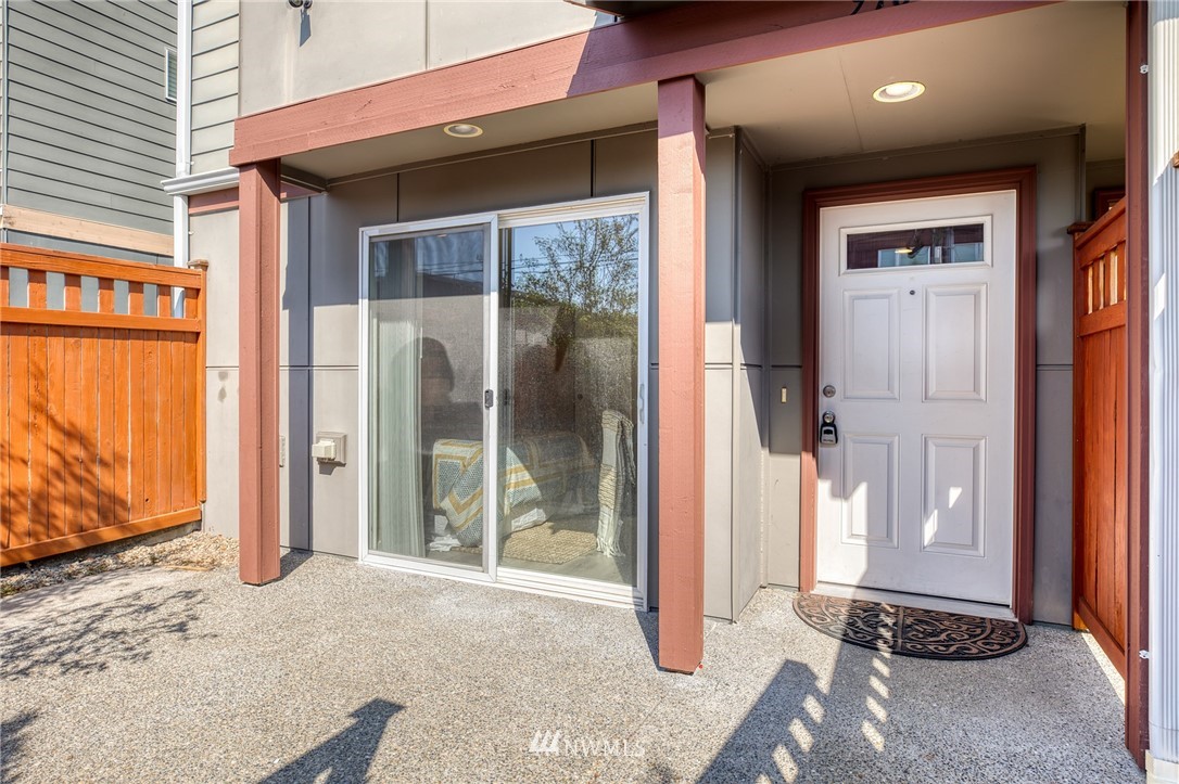 946 North 96th Street Seattle, WA 98103 - Photo 3 of 24 a backyard of a house with glass door and glass door