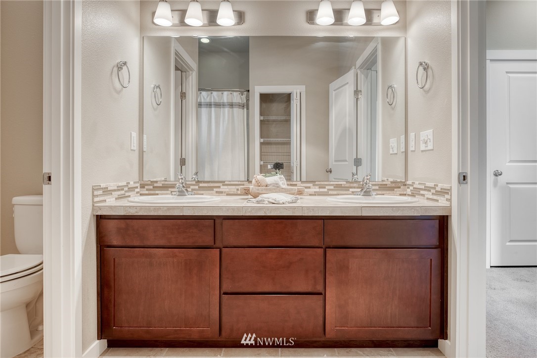 946 North 96th Street Seattle, WA 98103 - Photo 21 of 24 a bathroom with a sink vanity and a mirror