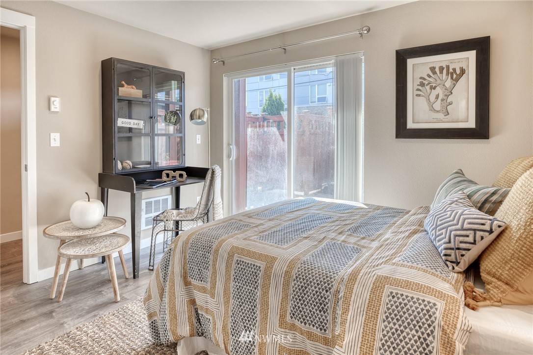946 North 96th Street Seattle, WA 98103 - Photo 5 of 24 a bedroom with a bed and wooden floor