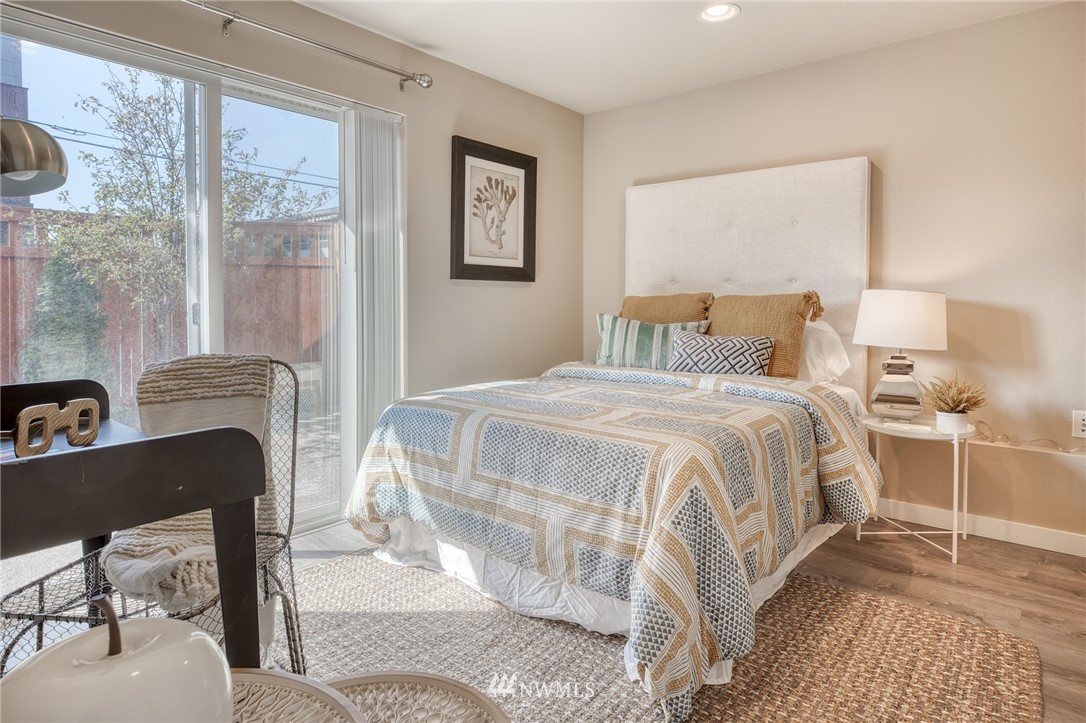 946 North 96th Street Seattle, WA 98103 - Photo 6 of 24 a bedroom with a bed and wooden floor