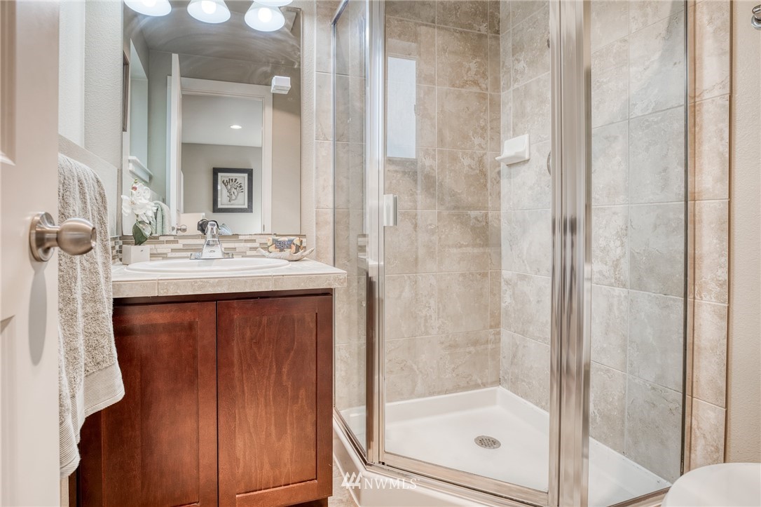 946 North 96th Street Seattle, WA 98103 - Photo 7 of 24 a bathroom with a sink and a mirror