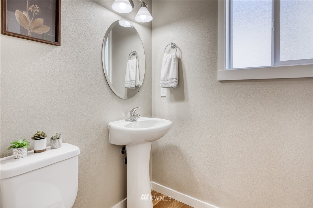 946 North 96th Street Seattle, WA 98103 - Photo 8 of 24 a bathroom with a sink and a mirror