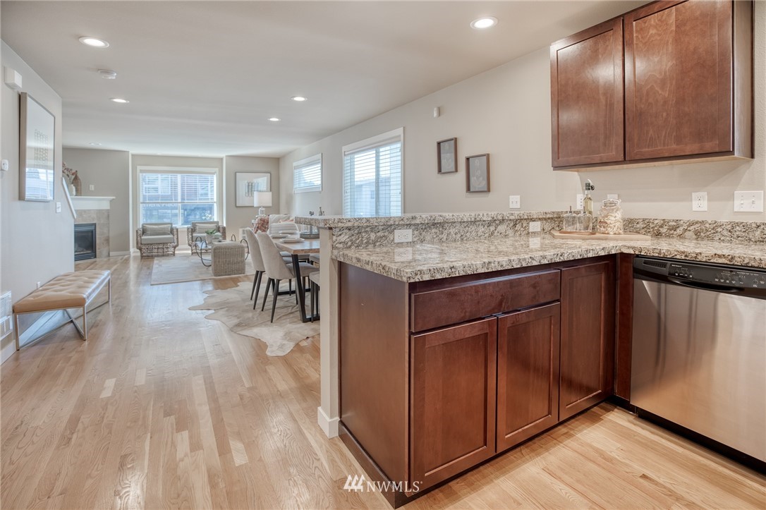 946 North 96th Street Seattle, WA 98103 - Photo 9 of 24 a kitchen with lots of counter top space and painting on the wall