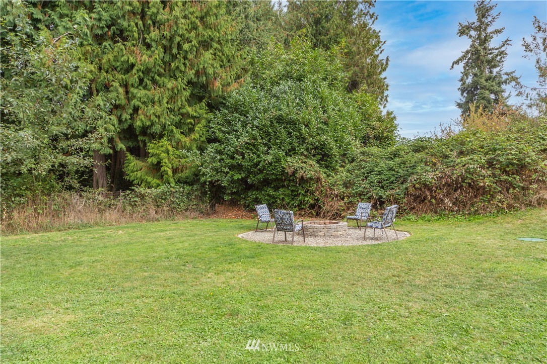 124 Fitzgerald Road Sequim, WA 98382 - Photo 22 of 25 a view of a lake with a yard