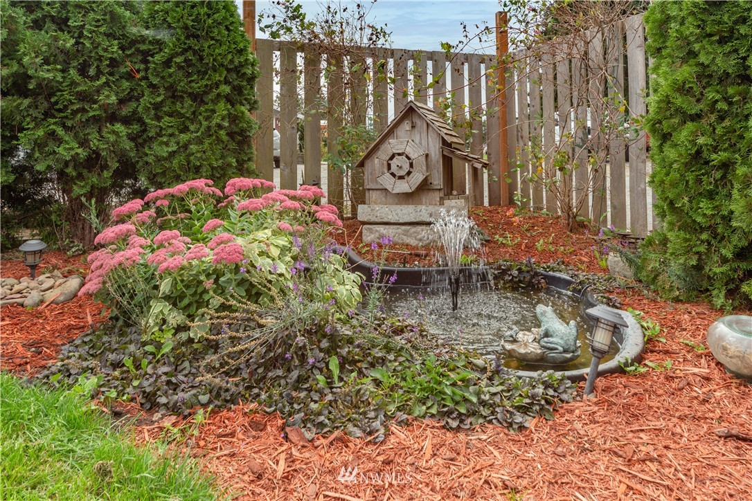 124 Fitzgerald Road Sequim, WA 98382 - Photo 4 of 25 a backyard of a house with yard and outdoor seating