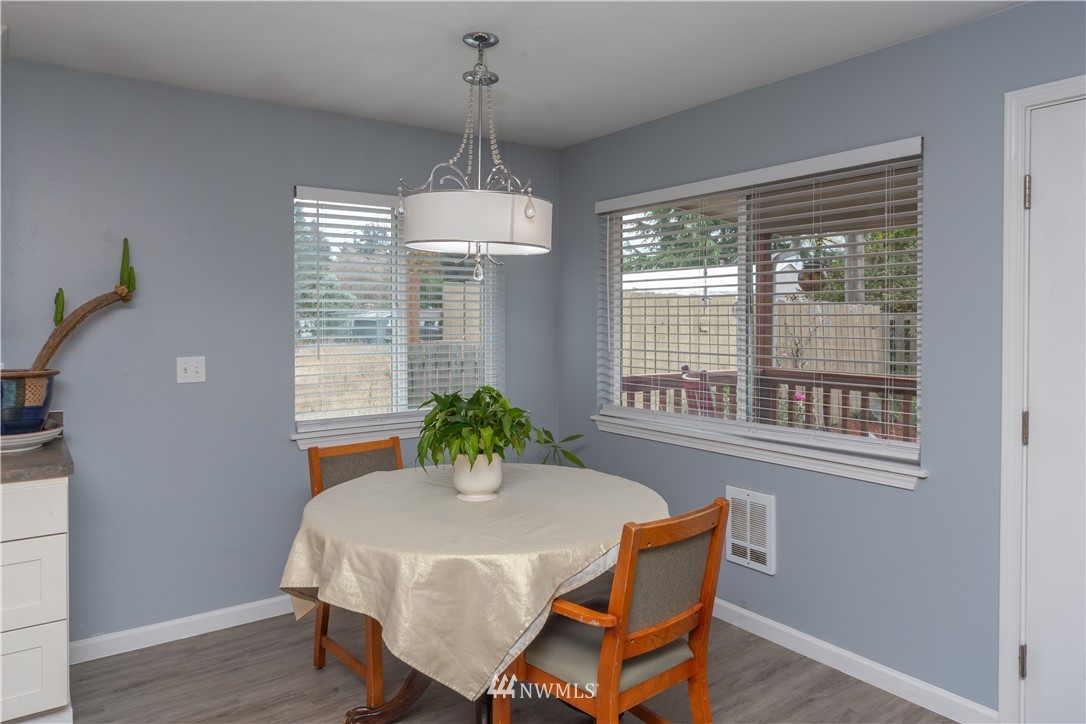 124 Fitzgerald Road Sequim, WA 98382 - Photo 7 of 25 a dining room with furniture a chandelier and wooden floor