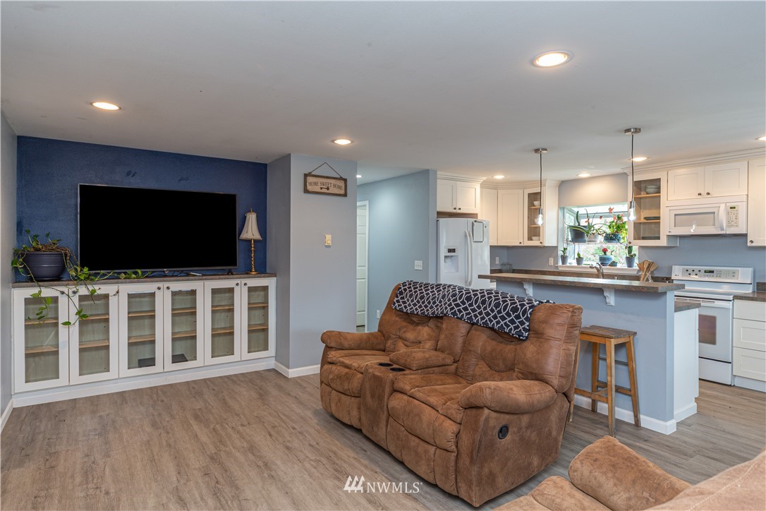 124 Fitzgerald Road Sequim, WA 98382 - Photo 8 of 25 a living room with furniture kitchen view and a flat screen tv