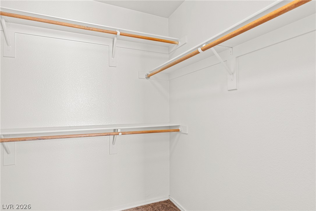 1815 Stablegate Avenue Henderson, NV 89012 - Photo 21 of 28 Ample hanging space and shelving offer versatile storage solutions within this well-organized closet.