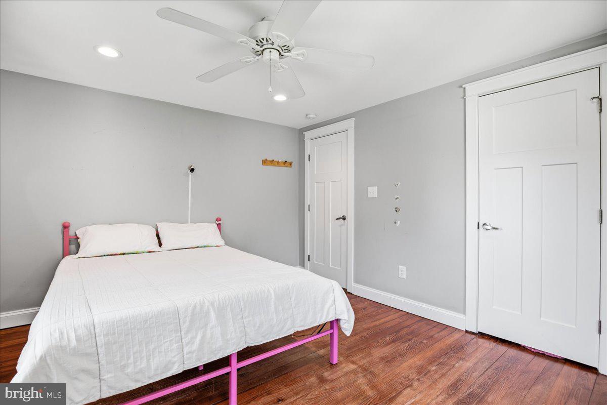 16146 Thomas Road Piney Point, MD 20674 - Photo 44 of 70 a bedroom with a bed and a chandelier