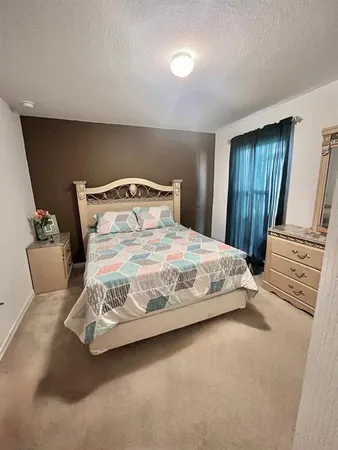 a bedroom with a bed and a mirror