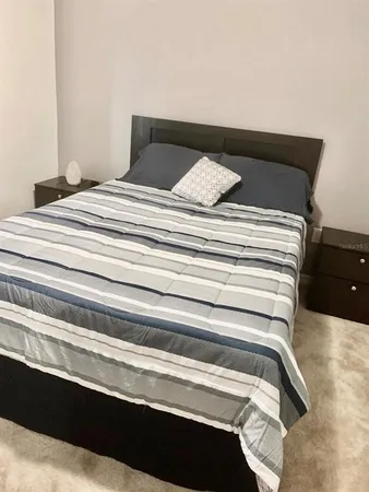 a bedroom with a bed and a view of closet