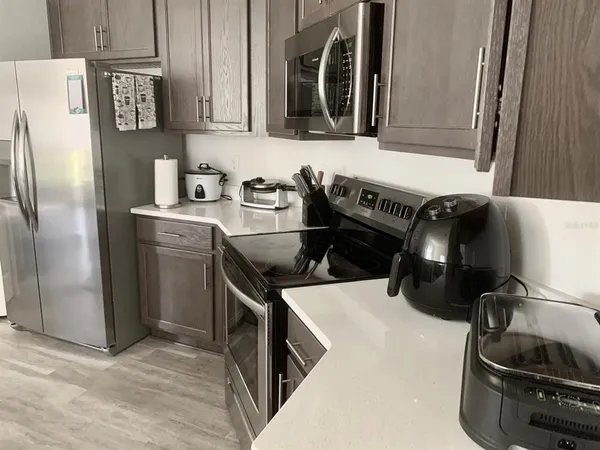 a kitchen with a refrigerator and a stove top oven