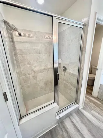 a bathroom with a glass door shower