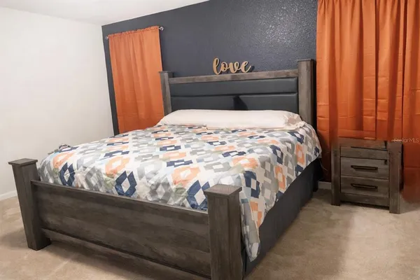 a bed sitting in a bedroom next to a window