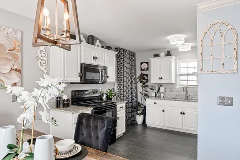 a kitchen with refrigerator and cabinets