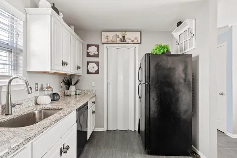 a kitchen with a sink stove and cabinets