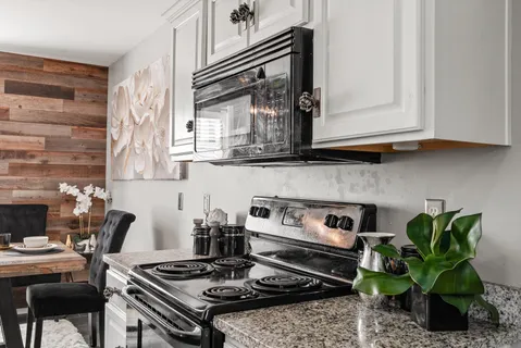a kitchen with granite countertop a sink and a stove