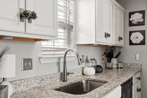 a bathroom with a sink vanity mirror and toilet