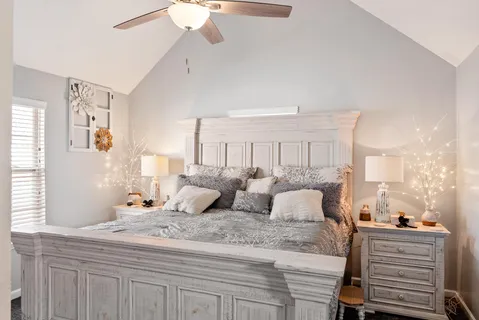 a bedroom with a bed and a window