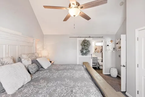 a bathroom with a sink vanity mirror and toilet