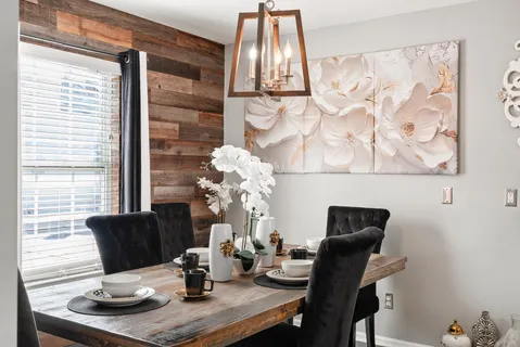 a dining room with furniture and wooden floor