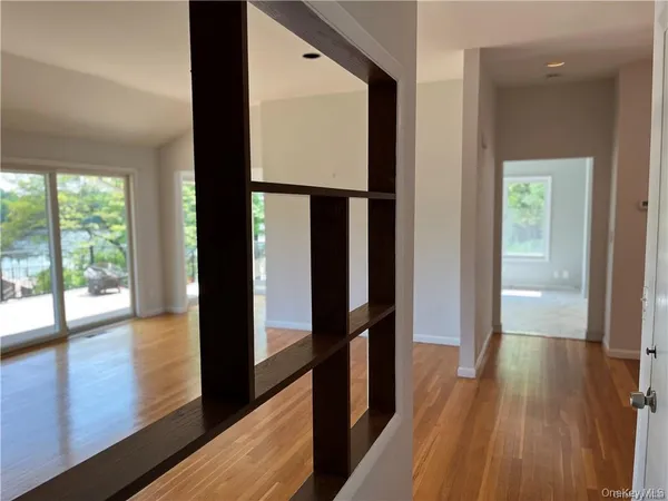 a view of hallway with wooden floor and stairs