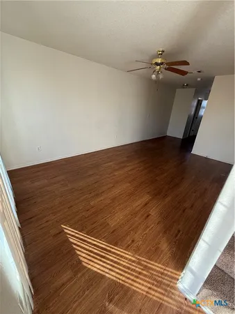 a view of a room with wooden floor
