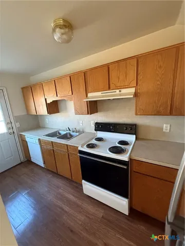 a kitchen with wooden floors and a stove