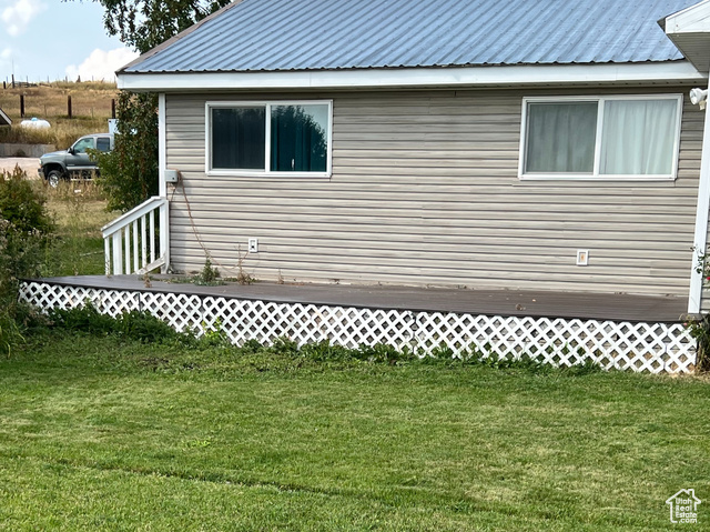108 South Road Montpelier, ID 83254 - Photo 3 of 36 View of side of property with a metal roof and a lawn