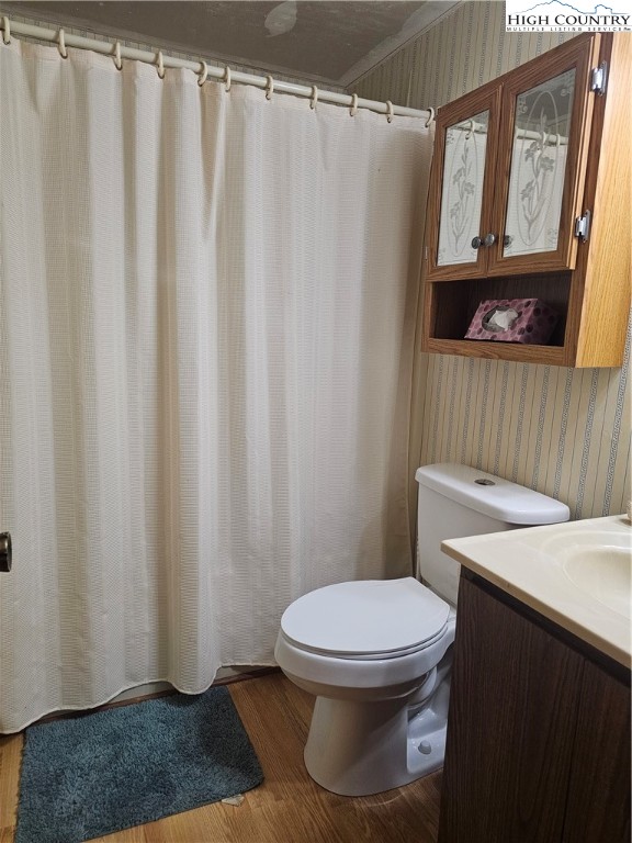 189 Pine Loop Newland, NC 28657 - Photo 13 of 17 a white toilet sitting next to a shower curtain