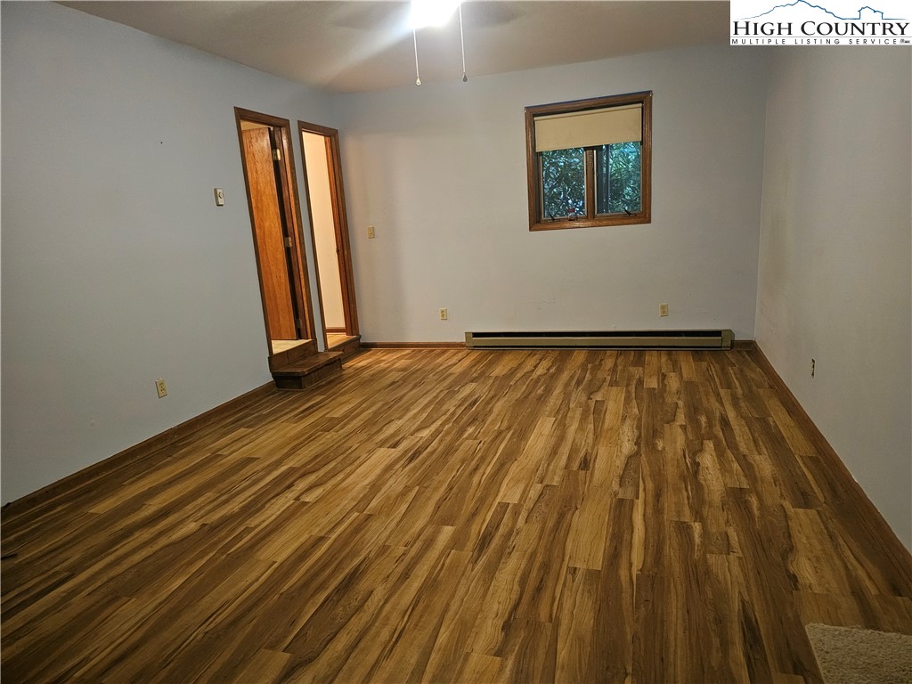 189 Pine Loop Newland, NC 28657 - Photo 14 of 17 a view of an empty room with wooden floor and a window