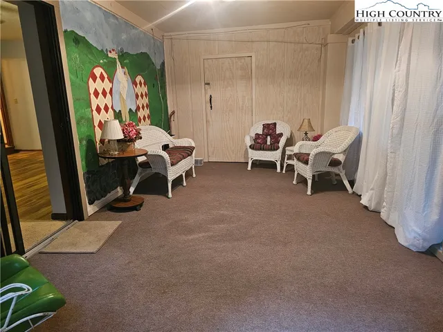 a view of a room with furniture and a window