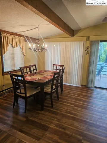 a dining room with furniture and wooden floor