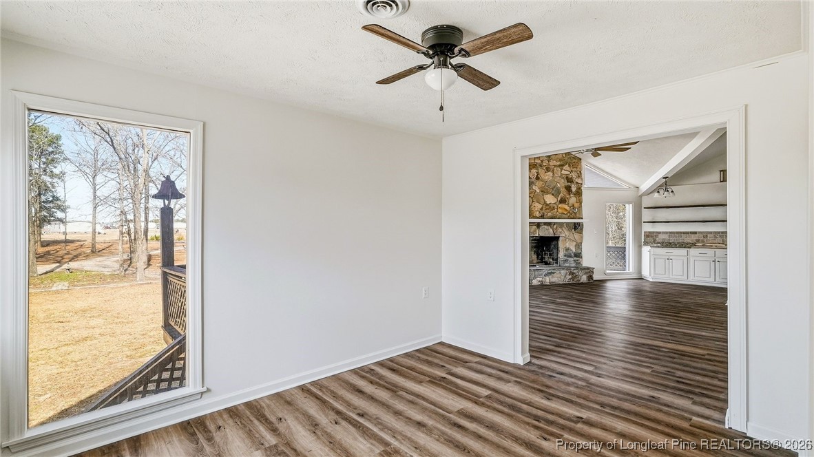 10765 Barker 10 Mile Road St. Pauls, NC 28384 - Photo 11 of 48 a view of empty room with wooden floor and fan