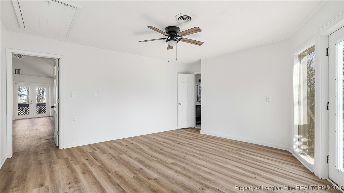 10765 Barker 10 Mile Road St. Pauls, NC 28384 - Photo 15 of 48 a view of a room with a ceiling fan and hardwood floor