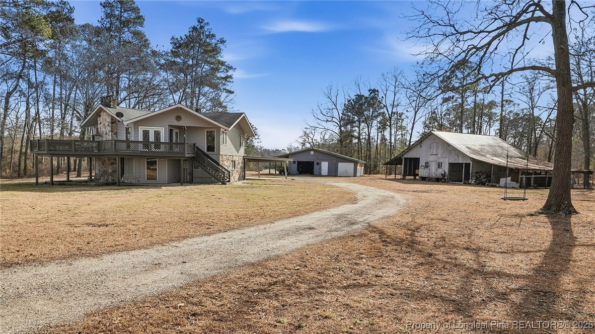 10765 Barker 10 Mile Road St. Pauls, NC 28384 - Photo 2 of 48 a front view of a house with large trees