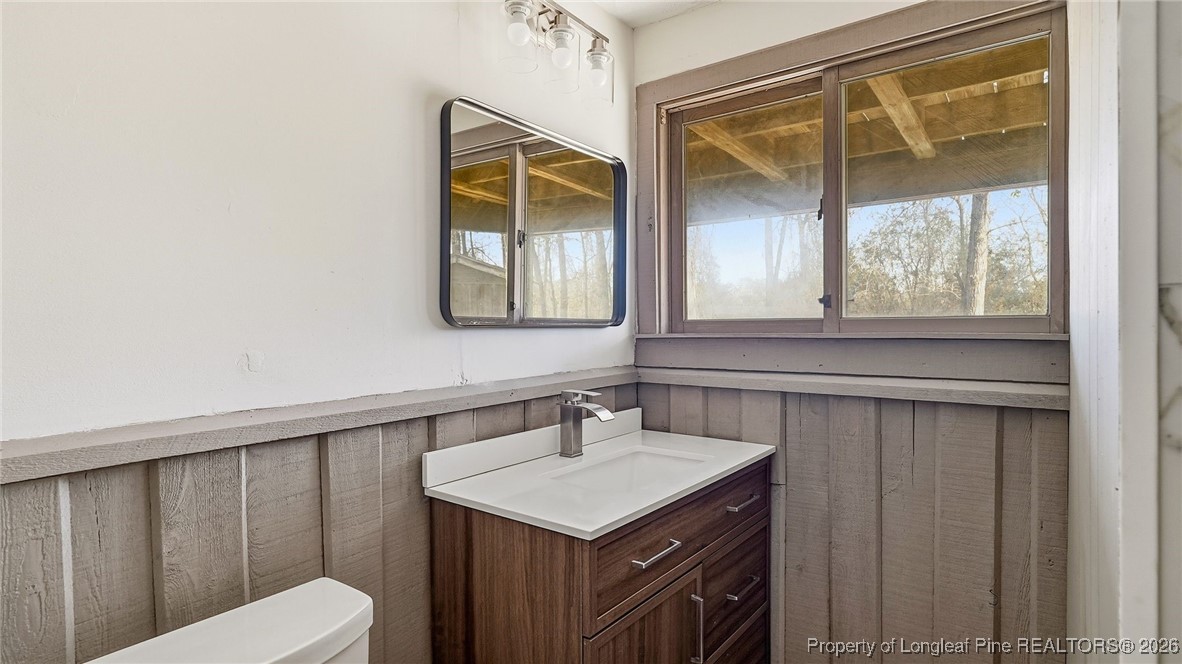 10765 Barker 10 Mile Road St. Pauls, NC 28384 - Photo 23 of 48 a bathroom with a sink and a mirror