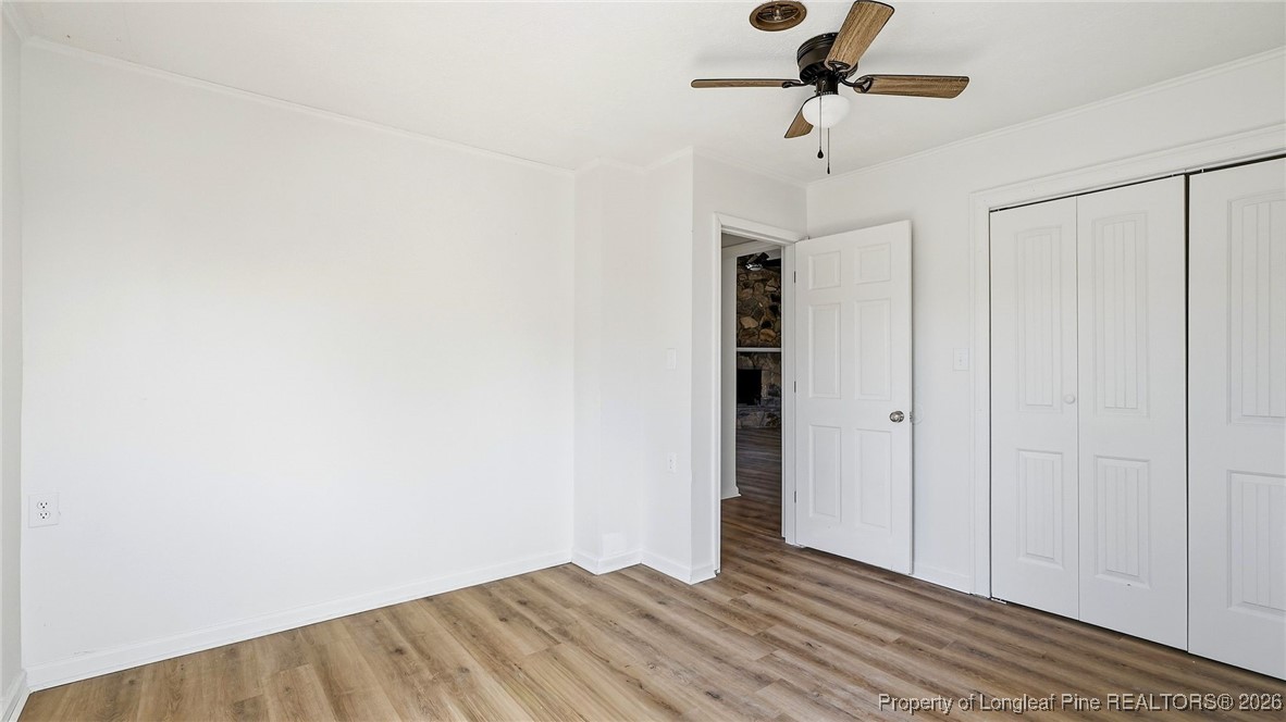 10765 Barker 10 Mile Road St. Pauls, NC 28384 - Photo 25 of 48 a view of a room with a ceiling fan and wooden floor