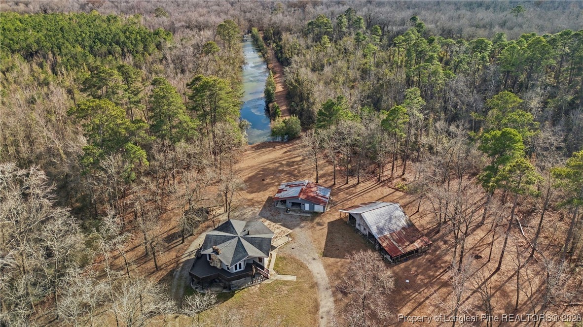 10765 Barker 10 Mile Road St. Pauls, NC 28384 - Photo 3 of 48 a view of a backyard of the house
