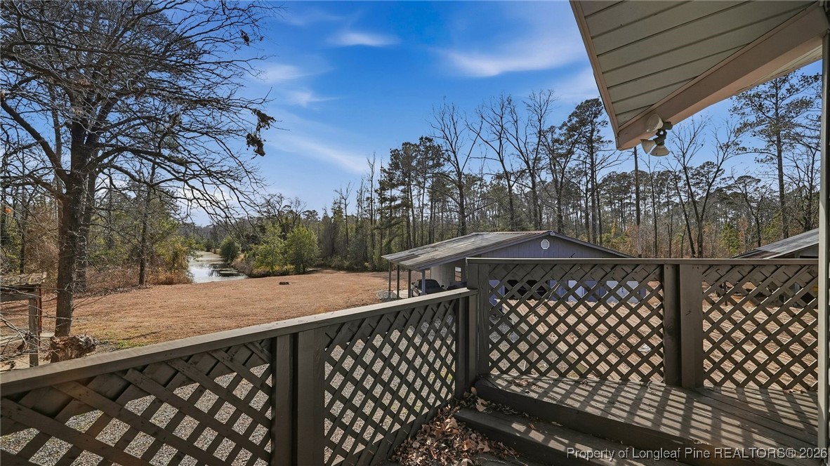 10765 Barker 10 Mile Road St. Pauls, NC 28384 - Photo 31 of 48 a view of a roof deck with wooden fence and floor