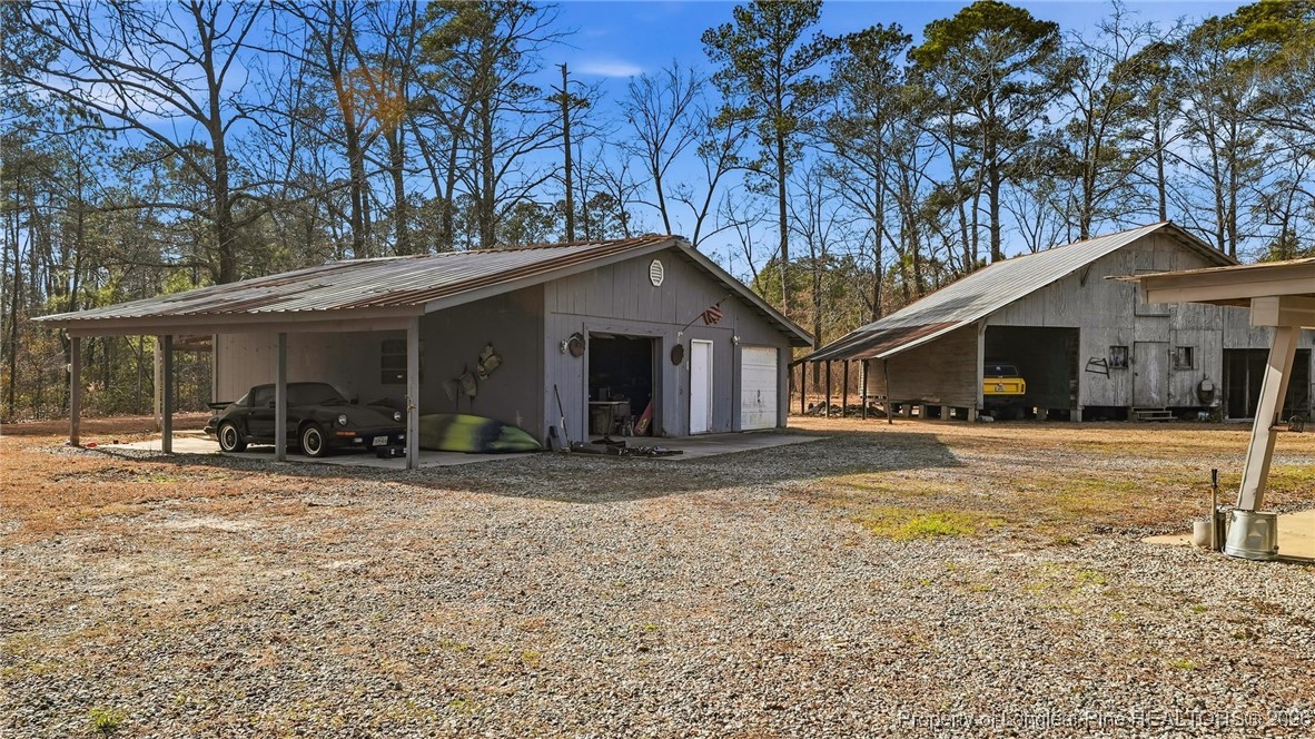 10765 Barker 10 Mile Road St. Pauls, NC 28384 - Photo 39 of 48 a front view of a house with a yard and garage