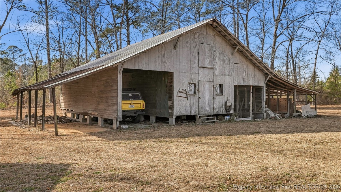 10765 Barker 10 Mile Road St. Pauls, NC 28384 - Photo 40 of 48 a backyard of a house with barbeque oven