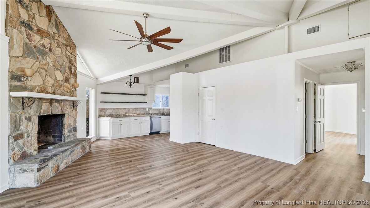 10765 Barker 10 Mile Road St. Pauls, NC 28384 - Photo 5 of 48 a view of a livingroom with wooden floor a ceiling fan and staircase