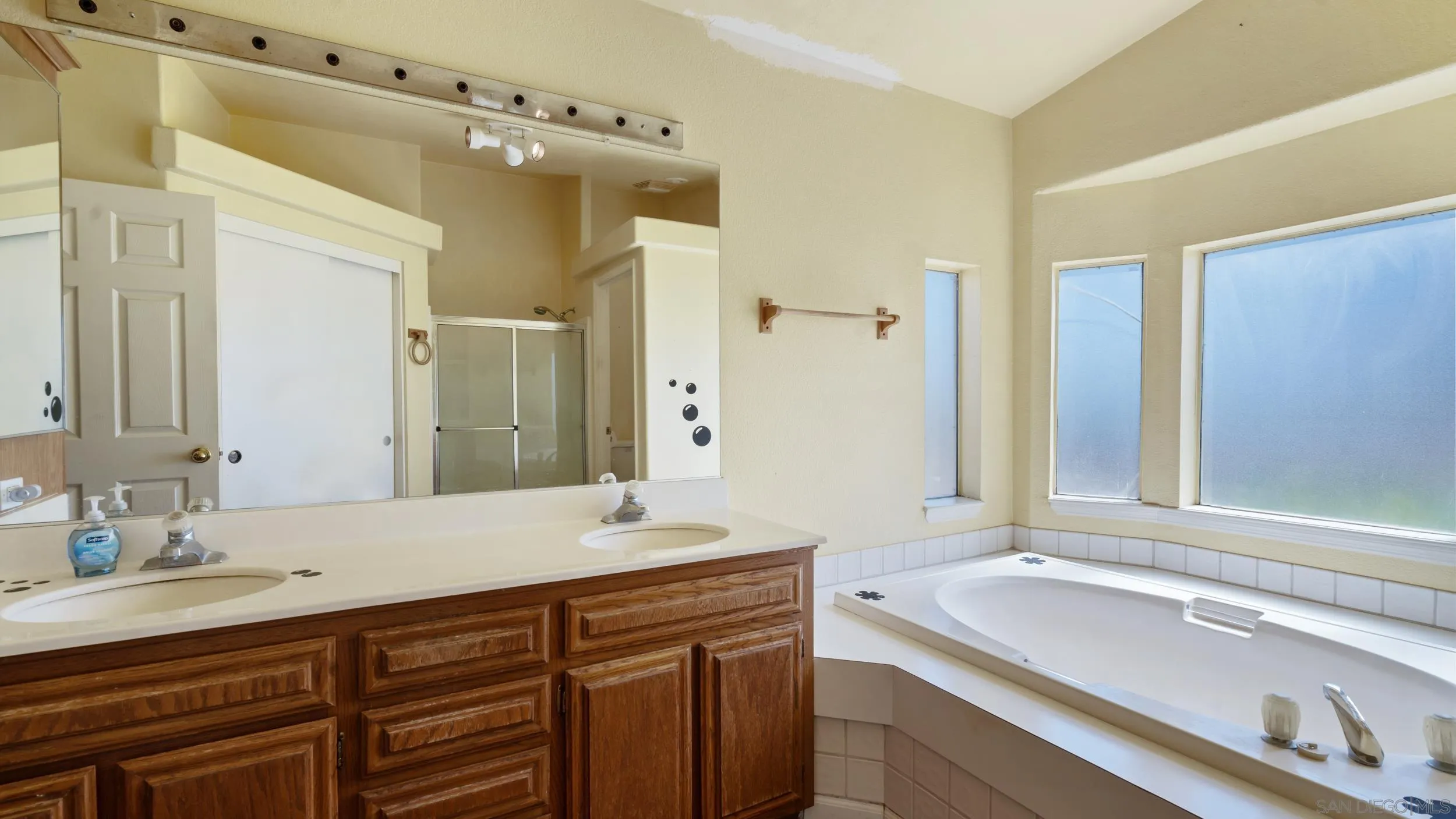 2075 Boulder Oaks Road Potrero, CA 91963 - Photo 22 of 41 a bathroom with a sink double vanity granite tub shower and a mirror