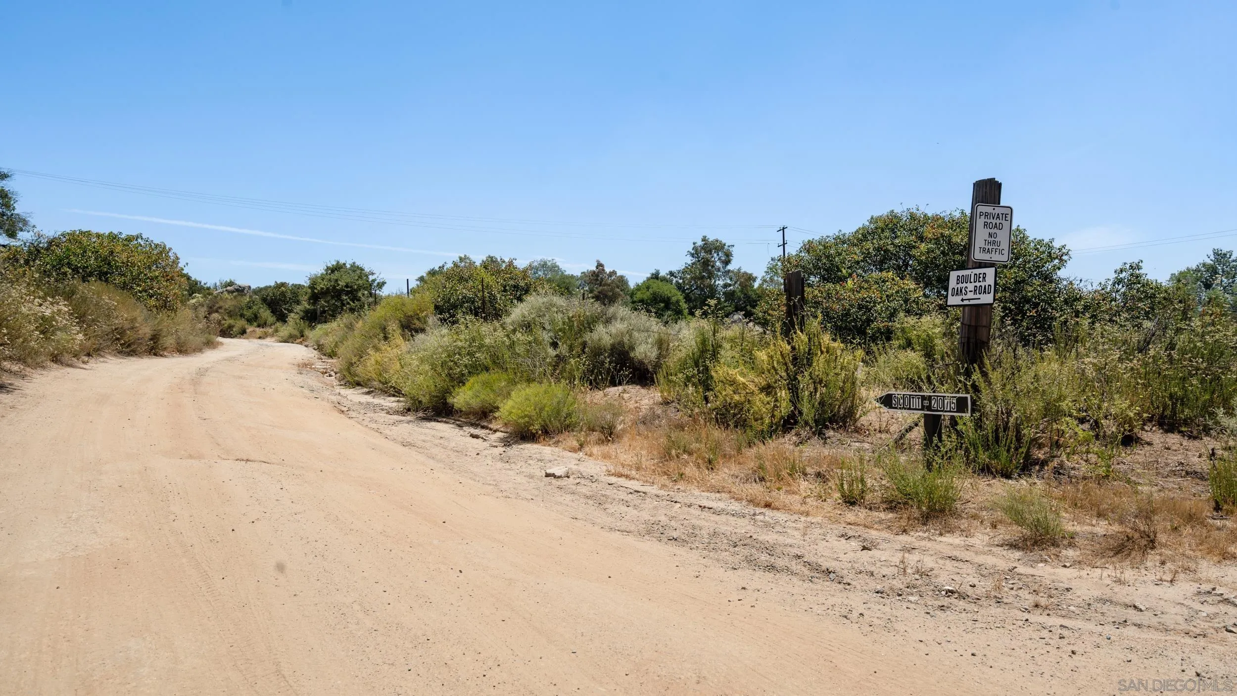 2075 Boulder Oaks Road Potrero, CA 91963 - Photo 36 of 41 a view of a dry yard with trees in the background