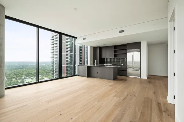 a kitchen with kitchen island granite countertop a refrigerator and a sink