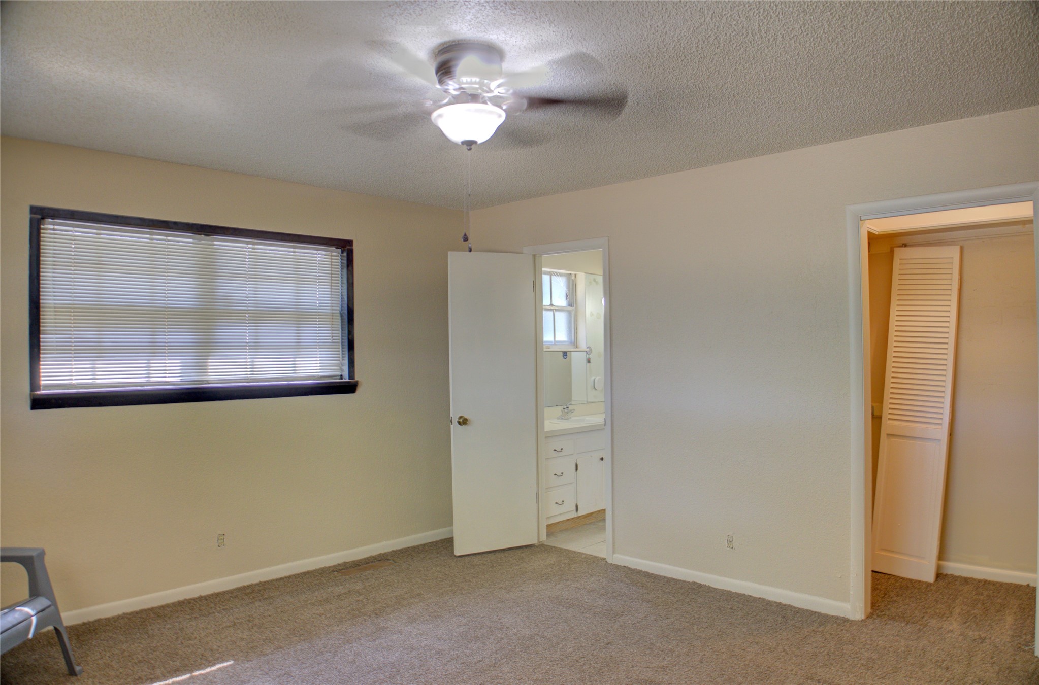 12420 South Garnett Road Broken Arrow, OK 74011 - Photo 36 of 44 Carpeted flooring, ceiling fan with integrated lighting, wall-mounted window blinds, and a built-in closet with louvered bi-fold doors