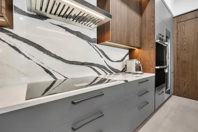 a large kitchen with stainless steel appliances lots of counter space and wooden floor